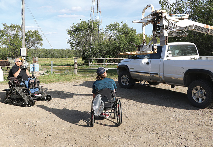 Merle Malin showing Levi how the lift operates.